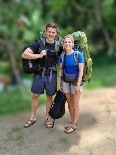 a man and a woman with backpacks on a trail at Coco Mount Residence - Hiriketiya in Dickwella