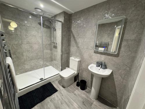 a bathroom with a shower toilet and a sink at 4 Town centre, Free off road parking, entire flat in Huntingdon
