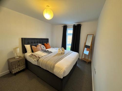 a bedroom with a large bed and a window at 4 Town centre, Free off road parking, entire flat in Huntingdon