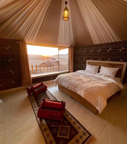 a bedroom with a bed with a view of the ocean at Sofia Valley Camp in Wadi Rum