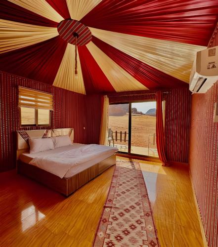 a bedroom with a bed with a red ceiling at Sofia Valley Camp in Wadi Rum