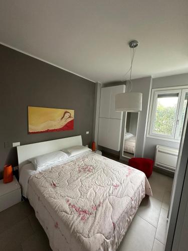 a bedroom with a large bed with a white comforter at Casa vacanza relax in Ortona