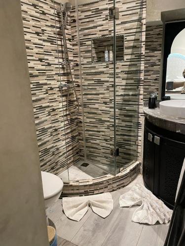 a bathroom with a shower with a toilet and a sink at RIAD NOLITA & SPA Kasbah in Marrakesh