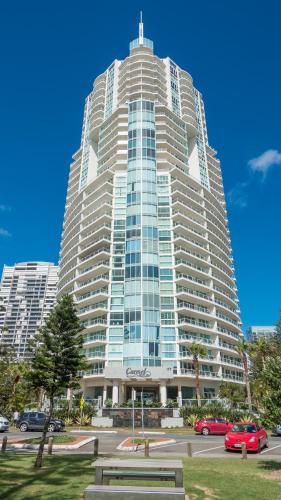a large building with cars parked in a parking lot at Carmel by the Sea in Gold Coast
