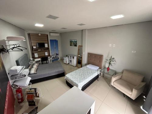 Ένα ή περισσότερα κρεβάτια σε δωμάτιο στο Loft confortável com Self Cheking