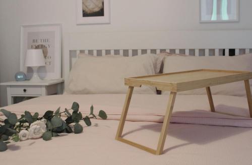 a bed with a wooden table on it with a table at Gio's Hygge Nest in Monte Grimano Terme