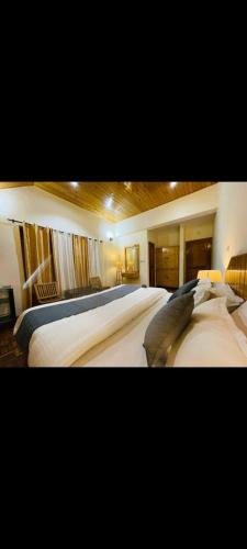 two beds in a hotel room with at Cloud 9 wooden villa in Manāli