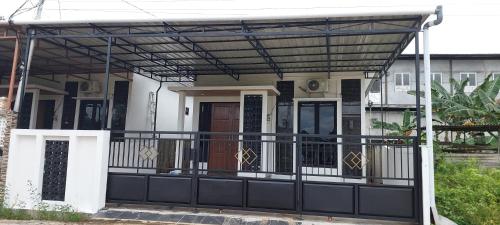 awning over a front porch of a house at Assa House in Pontianak