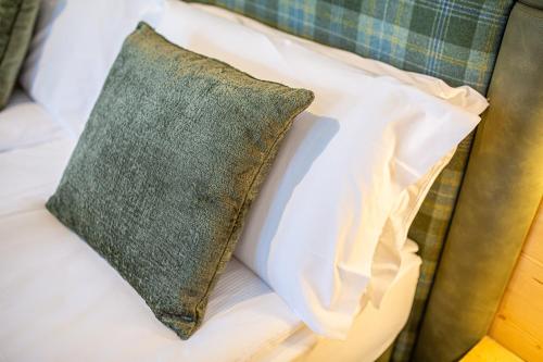 a pillow sitting on top of a bed at Hotel Nigritella in Selva di Cadore