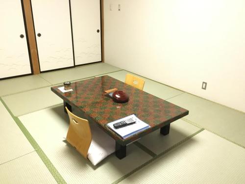 a table in a room with a table and chairs at Nikko Astraea Hotel in Nikko