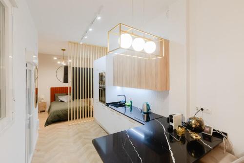 a kitchen with a black counter top in a room at Luxury central apartment in Madrid