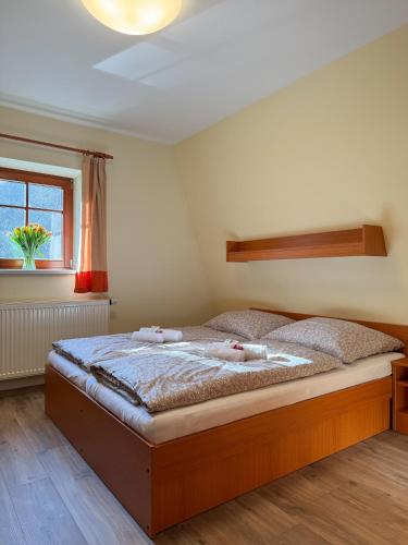 a bedroom with a large bed in a room at Penzion Čítkův Mlýn in Šluknov