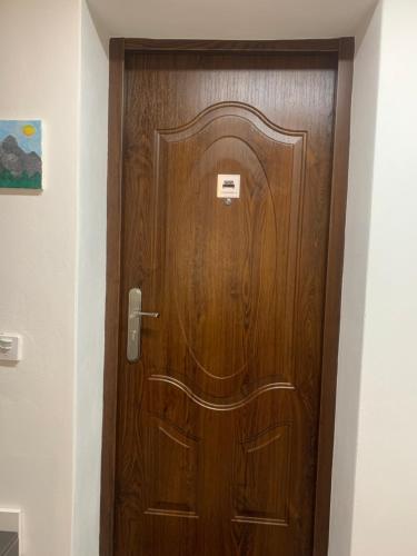 a wooden door in a hallway with a sign on it at Květinové apartmány Horní Planá in Horní Planá