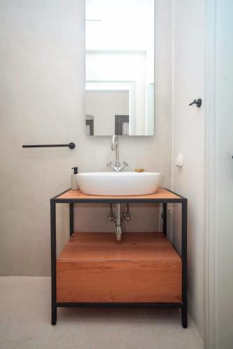 a bathroom with a sink and a mirror at Samos Serenity - Classic Retreat near the beach in Koumeika
