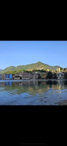 a view of a river with mountains in the background at La perla del Lago d Orta in Omegna