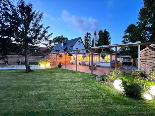 a backyard with a house with a patio at Wiesenau Apartments by Restaurant WIESENAU in Prerow