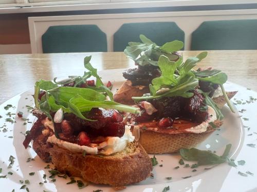 a plate with three sandwiches on a table at Wiesenau Apartments by Restaurant WIESENAU in Prerow