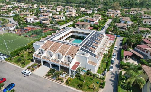 an aerial view of a building with a swimming pool at Limen Wellness Hotel & Spa in Campofelice di Roccella