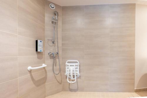 a shower stall in a bathroom with a shower at Kyriad Digne-Les-Bains in Digne-les-Bains