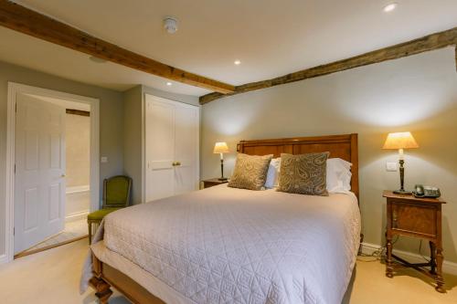 a bedroom with a large bed in a room at The Crown, Bildeston in Bildeston