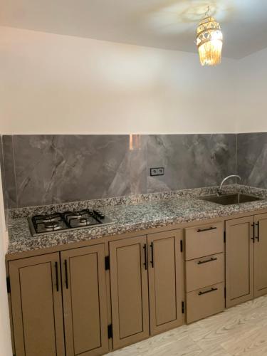 a kitchen with a sink and a counter top at Nomad Surf Lodge in Imsouane