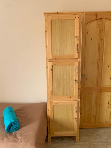 a bedroom with a bed and a wooden cabinet at Nomad Surf Lodge in Imsouane