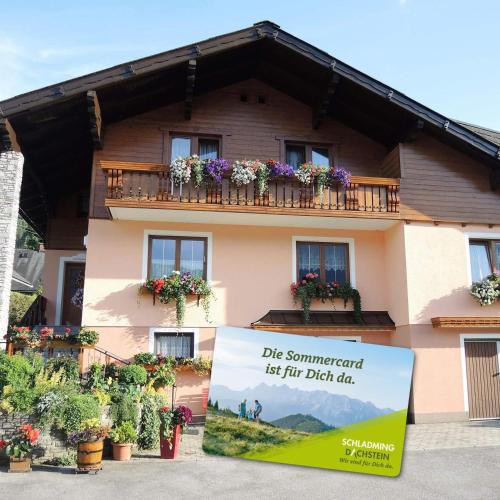 a building with a sign in front of it at Appartement am Hauser Kaibling in Haus im Ennstal