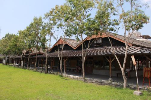 a building with trees in front of it at CHECK inn SELECT Hualien LinSen in Hualien City