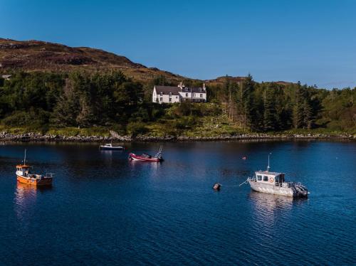 a group of boats in a large body of water at Eddrachilles Hotel in Scourie