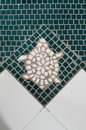 a tile floor with a turtle design on it at Lemon Tree Lanai in Keaau