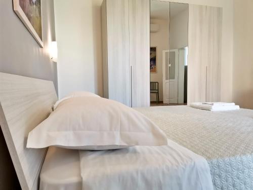 a bedroom with two beds and a mirror at L'altro Krisà in Bari