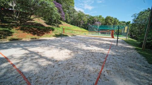 a volleyball court with a net in a field at Eldorado Atibaia Eco Resort in Atibaia