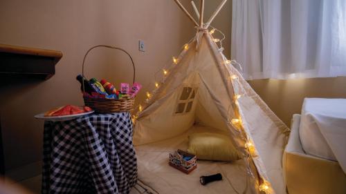 a room with a tent with lights on a bed at Eldorado Atibaia Eco Resort in Atibaia