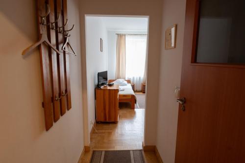 a hallway with a room with a bed and a door at Pokoje Gościnne Dom św. Szymona in Kraków