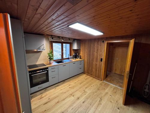 a kitchen with wooden walls and a wooden floor at Landhaus Lerch in Gaschurn