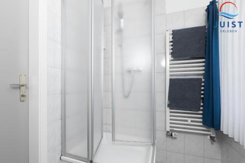 a shower with a glass door in a bathroom at Töwerland Zimmer 7 in Juist