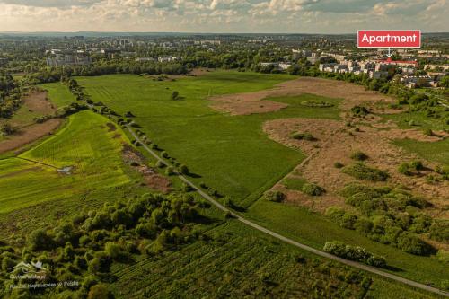 an aerial view of a green field with a sign at Twoje prywatne SPA - jacuzzi, sauna, tężnia solankowa in Kraków