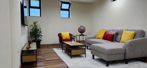 a living room with a couch and a table at Cozy & Modern 2-Bedroom Unit in Addis Ababa