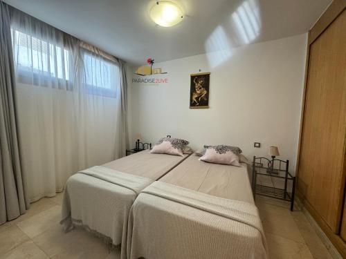 A bed or beds in a room at Atlantida del Sol Corralejo