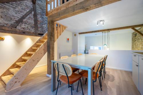 a kitchen and dining room with a table and chairs at La Rocha in La Roche-en-Ardenne