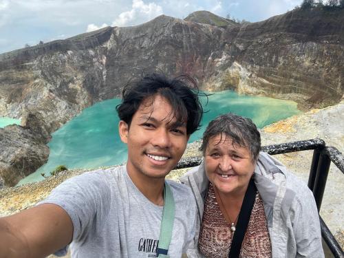 a man and a woman standing in front of a mountain at Lanina homestay in Ipi