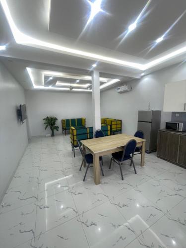a conference room with a wooden table and chairs at Mondialaw in Toubab Dialaw