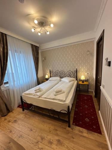 a bedroom with a bed and a ceiling fan at Hotel Boutique Cathedral Plaza Residences room for rent downtown in Bucharest