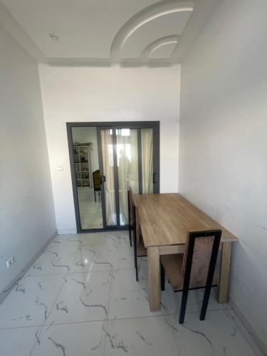 a dining room with a table and chairs and a mirror at Mondialaw in Toubab Dialaw