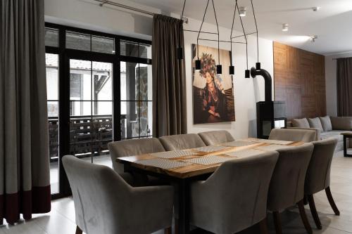 a dining room with a table and chairs at Mal'ovanka in Bukovel