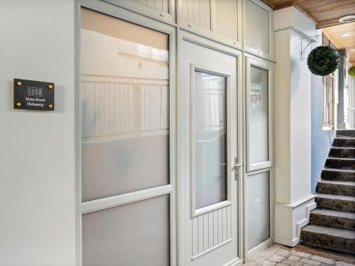 a pivot door in a house with a staircase at Apartment 297 - Clifden in Clifden