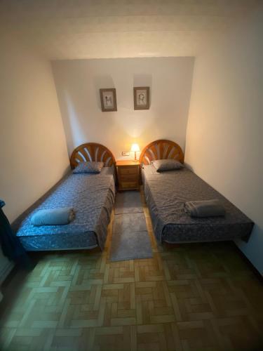 two beds in a small room with at Charming 8-Bed Villa in Girona in Girona