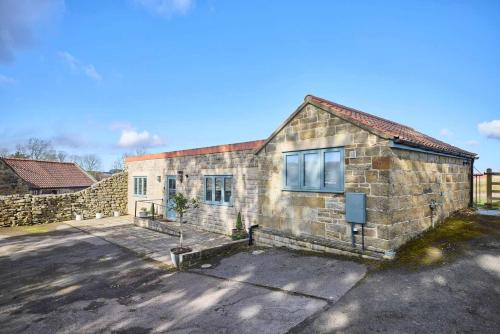 a stone house with a stone wall at Host & Stay - The Lodge in Whitby