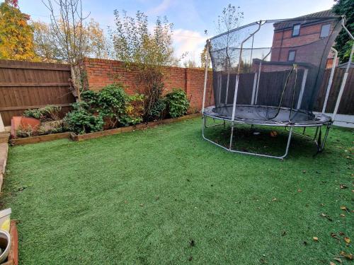 a trampoline in a yard in a backyard at 4 Bed Home in Altrincham by City SuperHost in Timperley