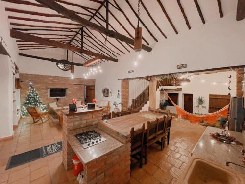 a large living room with a table and a fireplace at Casa Real Barichara in Barichara